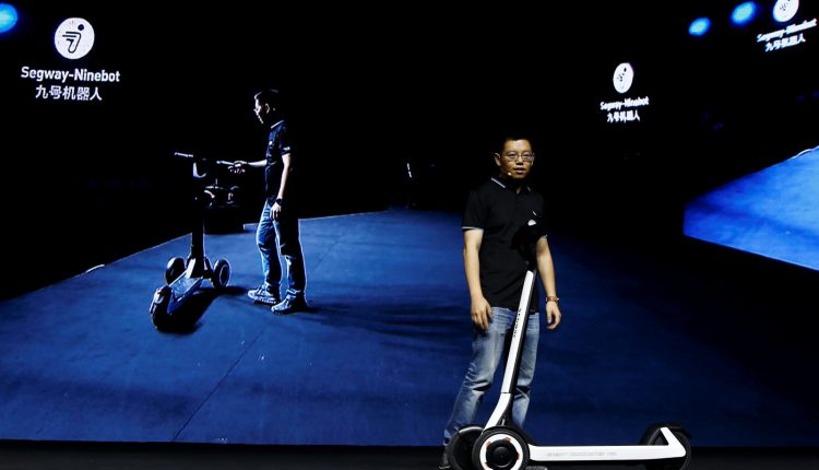 Ninebot President Wang Ye unveils semi-autonomous scooter KickScooter T60 that can return itself to charging stations without a driver, at a Segway-Ninebot product launch event in Beijing