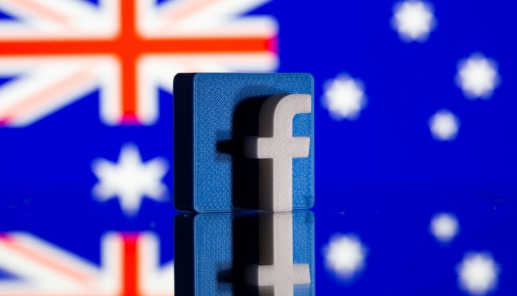 A 3D printed Facebook logo is seen in front of displayed Australia’s flag in this illustration photo