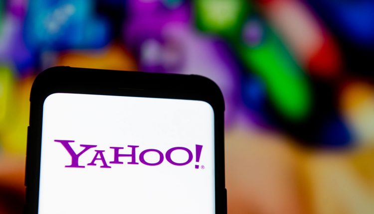In this photo illustration a Yahoo logo seen displayed on a