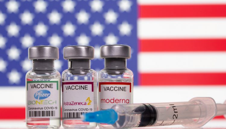 FILE PHOTO: Picture illustration of vials with Pfizer-BioNTech, AstraZeneca, and Moderna coronavirus disease (COVID-19) vaccine labels with a U.S. flag