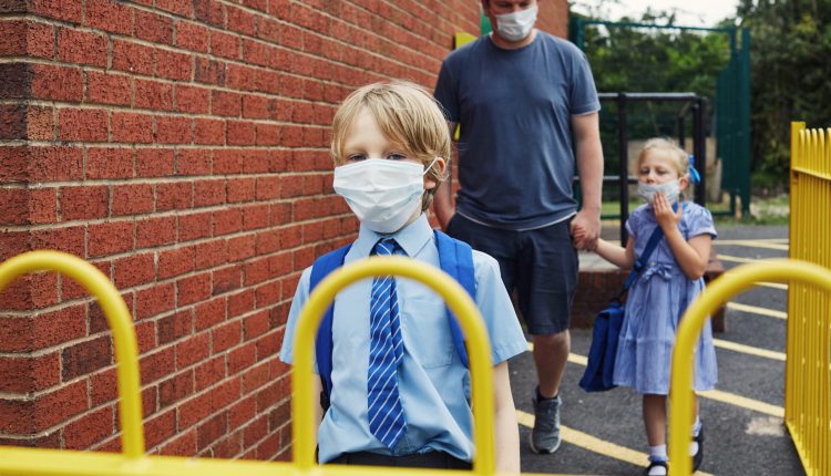Children going to school wearing face masks