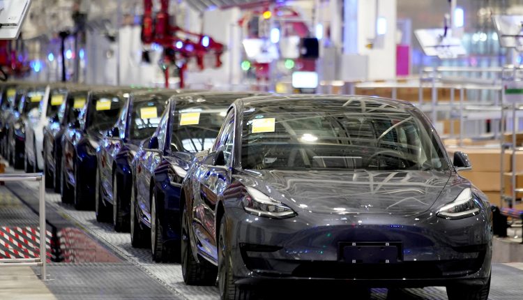 FILE PHOTO: Tesla China-made Model 3 vehicles are seen during a delivery event at the carmaker’s factory in Shanghai, China