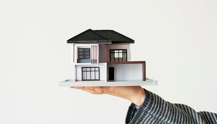 hand-presenting-model-house-home